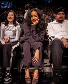 two women sitting next to each other at a basketball game