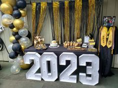 a graduation party with balloons and decorations on the table, including two large letters that read 205