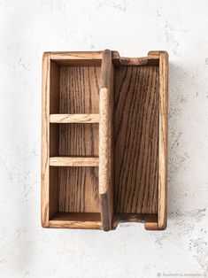 a wooden box with two compartments on the inside