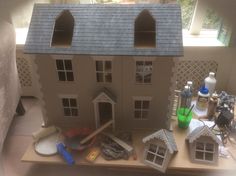 a doll house is shown with tools on the table