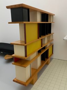 a book shelf sitting on top of a tiled floor