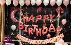 a birthday window display with balloons and streamers