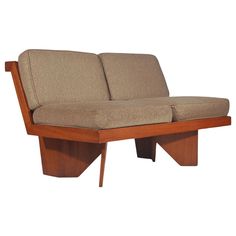 a brown couch sitting on top of a wooden frame