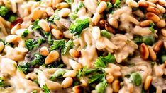 a close up view of some food with nuts and broccoli on it's side