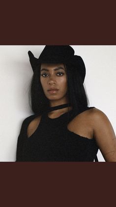 a woman with black hair wearing a hat and posing for a photo on instagram