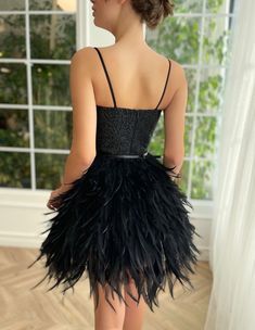 Dramatic black feathers swaddle around your body in harmony. It's intricately embellished top compliments your waist beautifully. Perfect combination of art deco and contemporary, this glamours mini dress is truly one of a kind. Elegant Flapper Dress With Feather Trim, Evening Flapper Dress With Feather Trim, Elegant Flapper Dress With Feather Trim For Cocktail, Elegant Feather Trim Flapper Dress For Cocktail, Elegant Cocktail Flapper Dress With Feather Trim, Chic Ostrich Feather Mini Dress For Evening, Elegant Party Flapper Dress With Feather Trim, Mini Gala Dresses With Feather Trim, Mini Gala Dress With Feather Trim