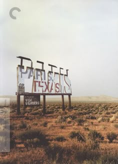 two billboards in the middle of an open field with no one around them on it