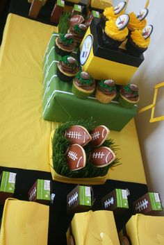 a football themed dessert table with cupcakes and snacks