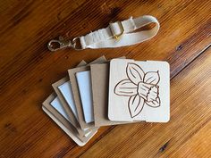 four wooden coasters sitting on top of a wooden table next to a keychain