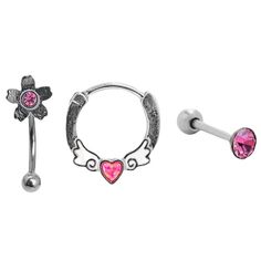 three pairs of piercings with pink stones