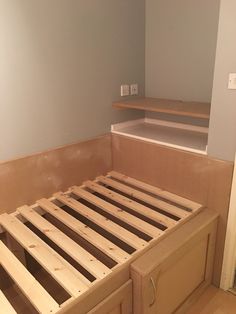 the bed frame is made up and ready to be built into the wall in the bedroom