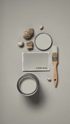 some paint and other items are arranged on a gray surface with the words studio grey written in white