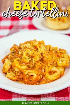 baked cheese tortellini in a white bowl on a red and white checkered tablecloth