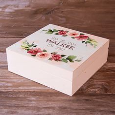 a personalized wooden box with flowers on it