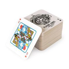 a stack of four playing cards sitting next to each other on top of a white surface