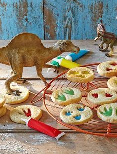 toy dinosaurs and cookies on a table