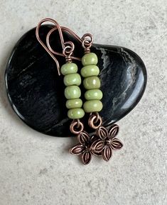 "green copper earrings   stacked bead earrings   boho dangle earrings * small African Maasai glass beads - handmade with varying size and shape - 2-3x4mm * opaque matte light green color * small antiqued copper plated flower charm - 10mm * antiqued copper plated hook ear wires * total length - 1 3/4\" * you can enter my shop here:    gypsydangles.etsy.com" Antique Charms, Charms Earrings, Diy Earrings Dangle, Natural Stone Earrings, Earrings Inspiration, Handmade Wire Jewelry, Handcrafted Earrings, Funky Jewelry, Copper Earrings