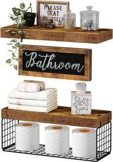 bathroom shelves with towels, toilet paper and other items on top of them in black metal baskets