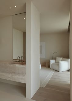 a bathroom with a sink, mirror and couch in it