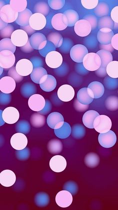 blurry image of pink and blue circles on purple background with space in the middle