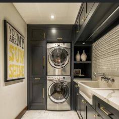 a washer and dryer in a small room with marble counter tops on the floor