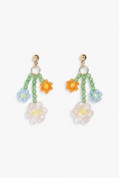 two pairs of colorful beaded earrings with flowers on each earring, hanging from gold - plated hooks