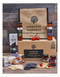 an assortment of food and condiments in a box on top of a wooden table