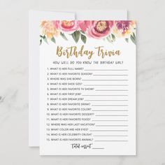 a birthday trivia card with pink flowers on the front and gold foil lettering that reads,