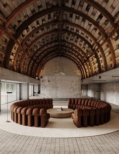 a circular room with couches and tables in it