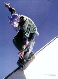 a man riding a skateboard up the side of a ramp