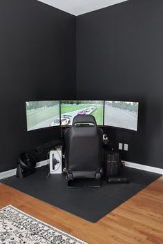 a room with two monitors and a chair