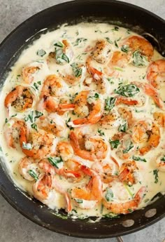 a skillet filled with shrimp and cheese