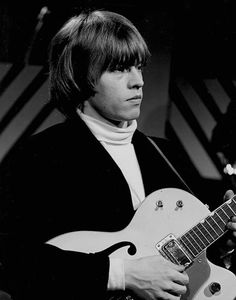 black and white photograph of a man playing an electric guitar