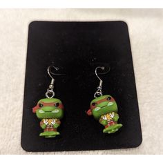 a pair of teenage mutant ninja turtle earrings