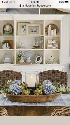 an image of a dining room table with flowers and candles in the centerpieces