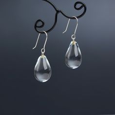 "These Small clear teardrop earrings are made of glass in lampwork technique. The earrings hooks are sterling silver and are hypoallergenic. These unique and beautiful earrings are like water drops frozen in glass! They are simple and elegant, very lightweight and comfortable to wear, perfect for everyday wear and for special occasions. 💕 You will definitely receive lots of compliments on your new earrings, everybody loves them, and you'll love them too! Dimensions: total length about 1 1/8\" i Elegant Glass Drop Jewelry, Elegant Drop Glass Jewelry, Elegant Drop-shaped Glass Jewelry, Glass Drop Earrings With Matching Set, Modern Clear Drop Jewelry, Glass Drop Earrings As Gift, Modern Glass Teardrop Earrings, Nickel-free Glass Drop Jewelry, Everyday Drop Jewelry With French Hook