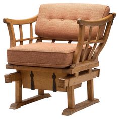 a wooden rocking chair with a cushion on it's seat and footrests