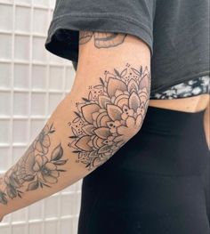 a woman's arm with flowers on it