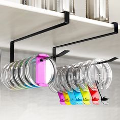 a rack with glasses hanging from it's sides and some clips attached to them