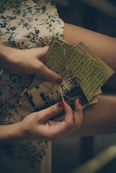 black and white photograph of hands holding papers