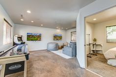 a bedroom with a bed, desk and television in it