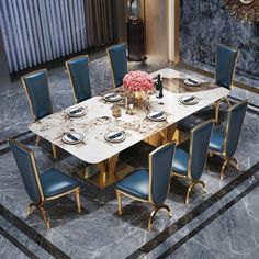 a marble dining table with blue chairs around it