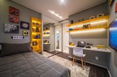 a bedroom with grey walls and yellow shelves