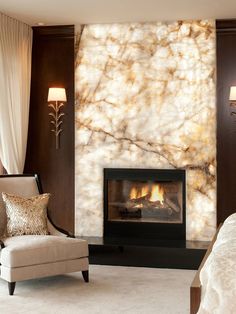 a bedroom with a fireplace and chair in front of the fire place that is built into the wall