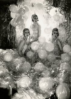 an old photo of three women sitting in bubbles