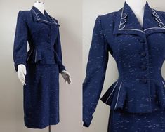 This is a stunningly sharp 50s blue wool suit set by Lilli Ann. It is a chic suit jacket with a wide lapel collar and geometric piping details. It has lightly padded shoulders, long cuffed sleeves, and a frilly peplum hem. It buttons down the center front with matching fabric covered buttons and with the peplum it makes the waist look cinched. There are also more white piping details in the peplum. The jacket is lined in a navy blue silk crepe with the Lilli Ann tag at the back of the neck and the QDA and union label at the side seam. The skirt is a simple but chic pencil style in matching blue wool and falls past the knees with a kick pleat in the back. The skirt fastens with a button on the waistband and a hidden metal zip. The skirt has the same silk crepe lining panel from the waist to Vintage Fitted Skirt Suit With Notch Lapel, Vintage Fitted Blue Suits, Blue Fitted Vintage Suit, Fitted Vintage Blue Suits, Vintage Blue Skirt Suit For Formal Occasions, Vintage Blue Semi-formal Suits, Vintage Fitted Suits For Office, Vintage Fitted Office Suit, Fitted Vintage Evening Suits