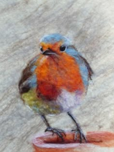 a drawing of a bird sitting on top of a piece of paper with colored paint