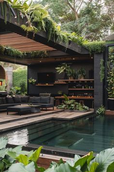 an outdoor living area with a pool and plants