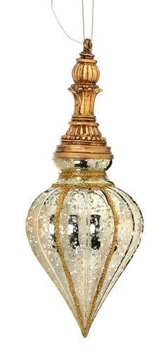 an ornate glass ornament hanging from a gold colored ceiling fixture with a white background