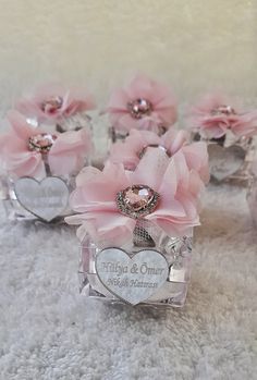 small pink flowers are placed in clear boxes